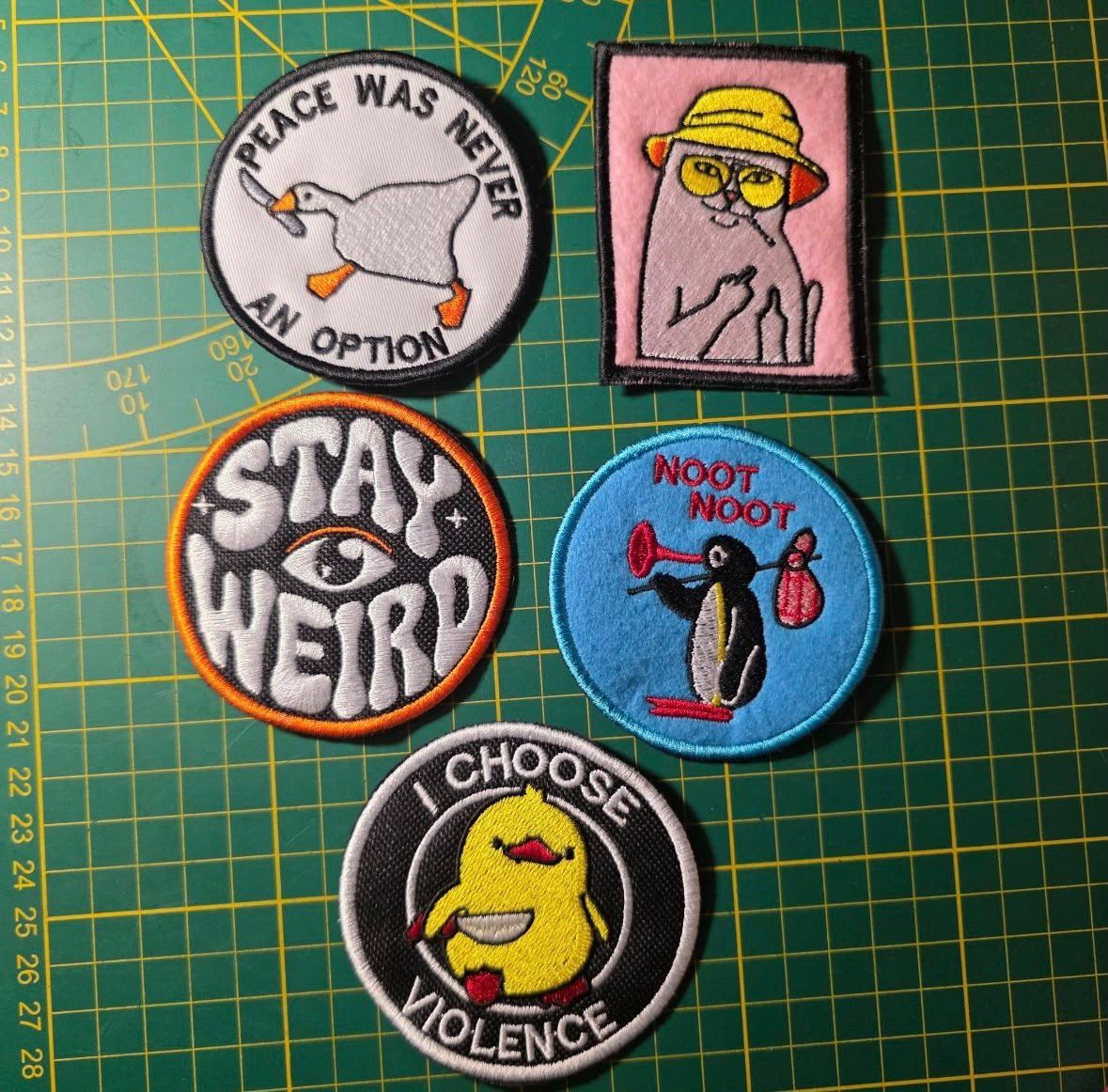 Character patches fresh off the hoop on the cutting mat