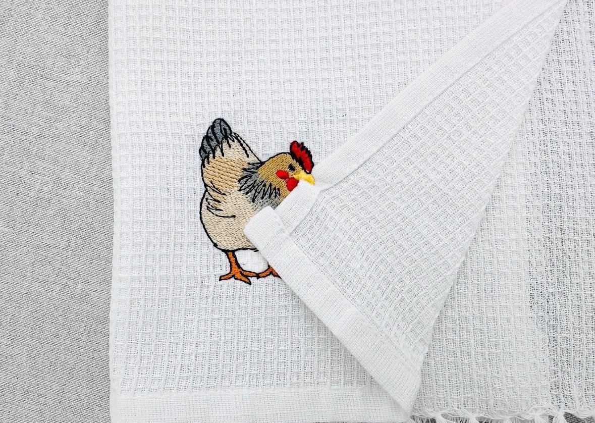 Hen motif stitched on a waffle weave kitchen towel