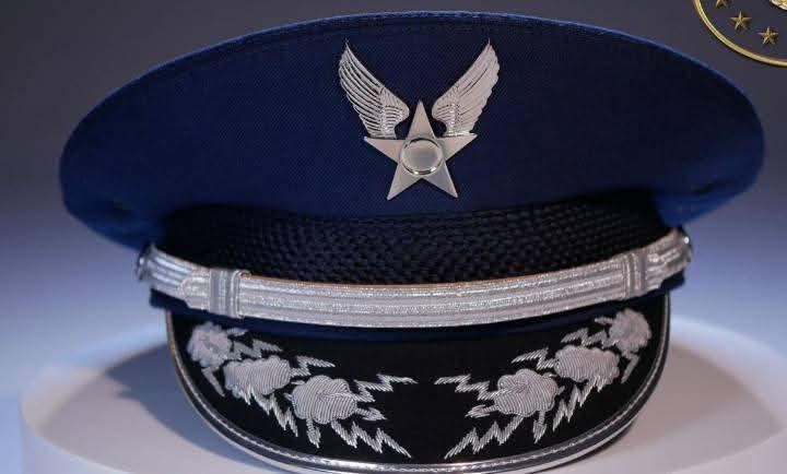 Blue cap with silver winged star and cloud and bolt peak