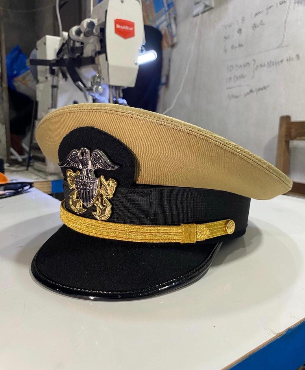 Khaki and black cap with eagle device and gold chin cord