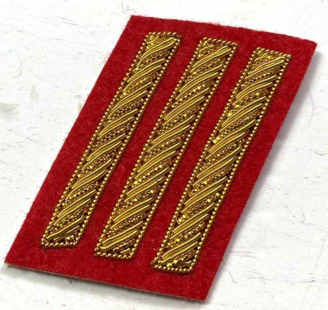 Three bar collar insignia in gold on scarlet felt