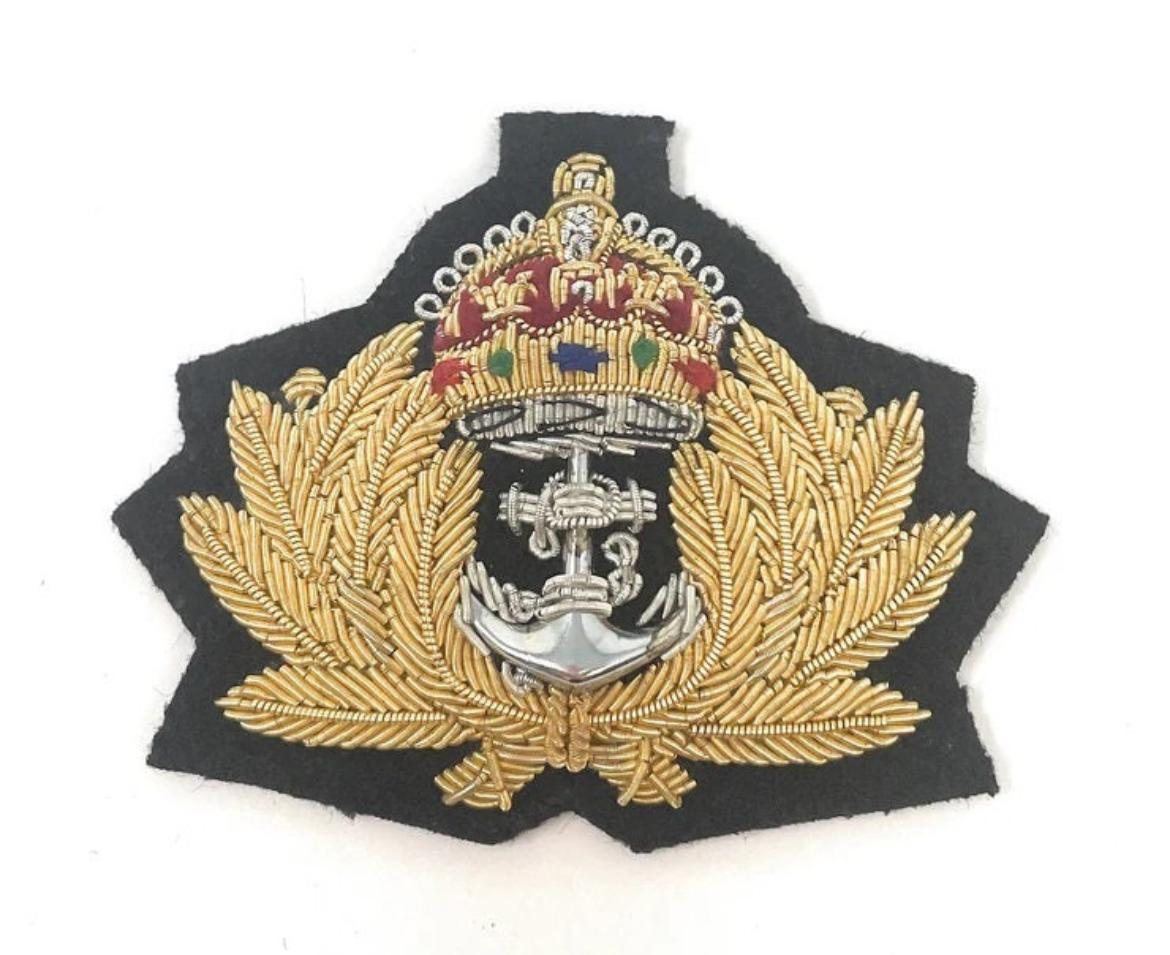 Crown and anchor cap badge in dense gold bullion