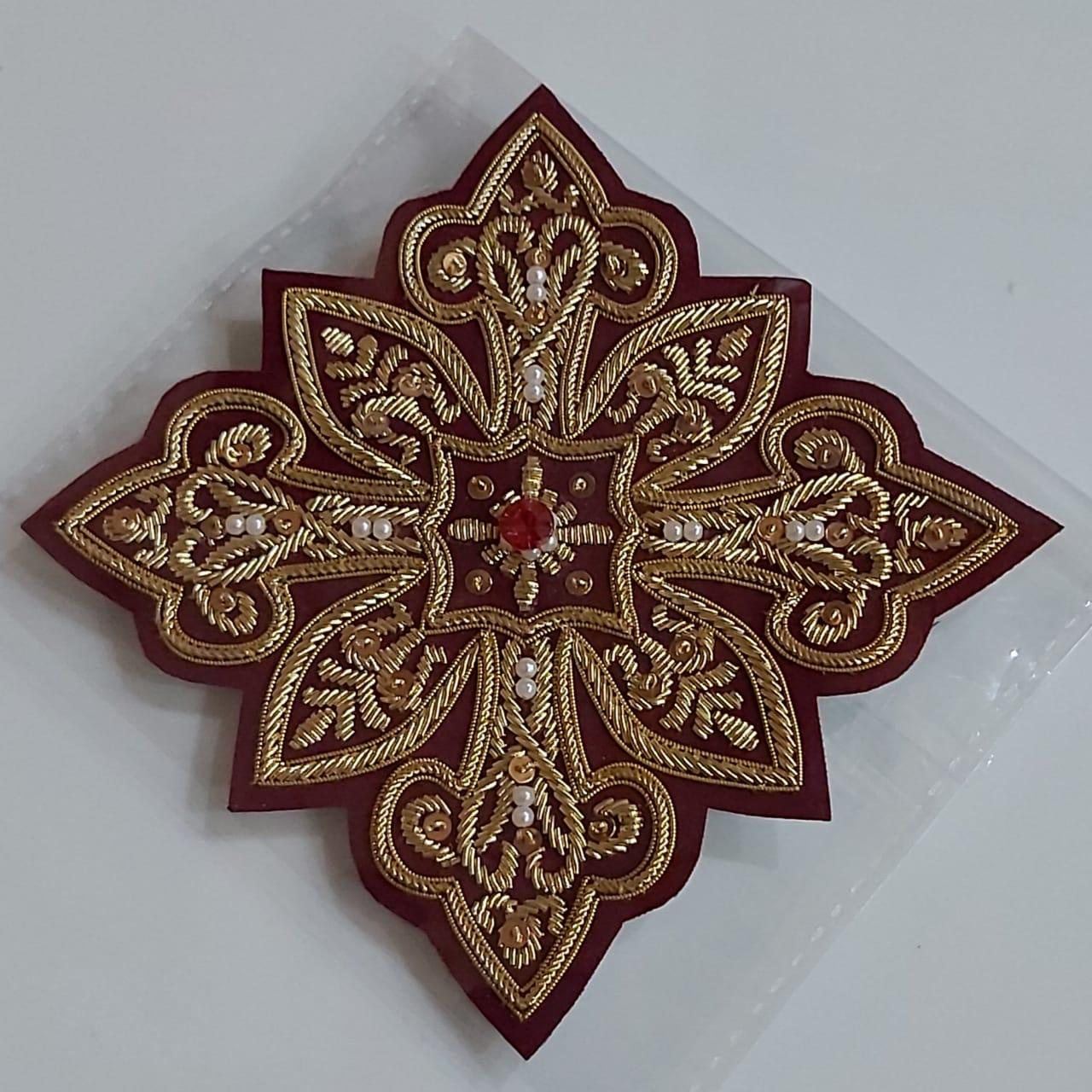 Maroon vestment cross with pearls, sequins and a ruby centre