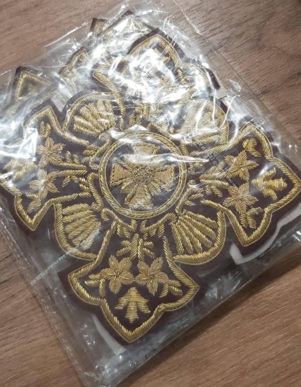 Vestment crosses in gold on brown, packed for dispatch