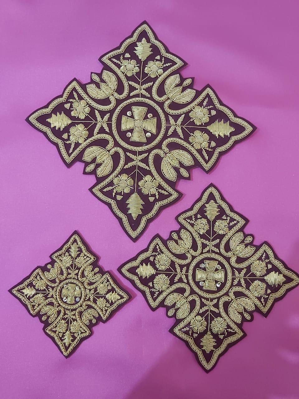 A matched vestment set in gold on maroon