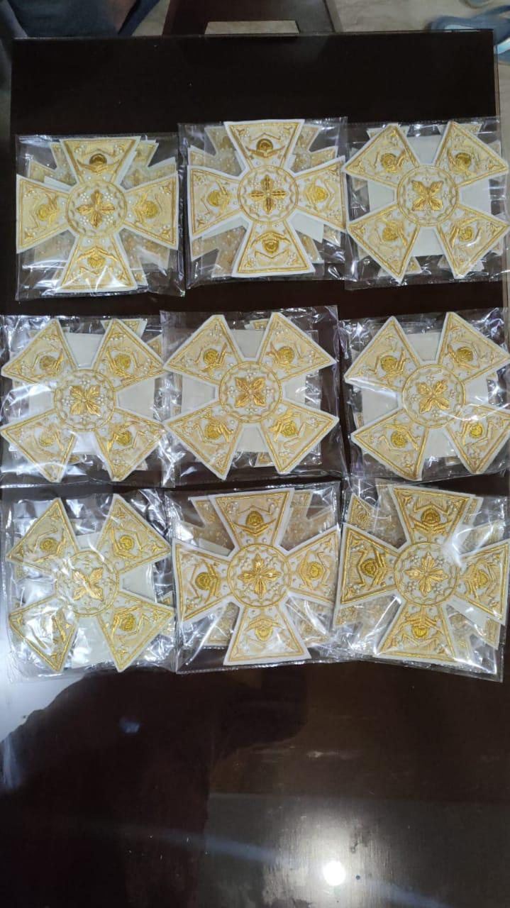 White and gold cross sets packed for dispatch
