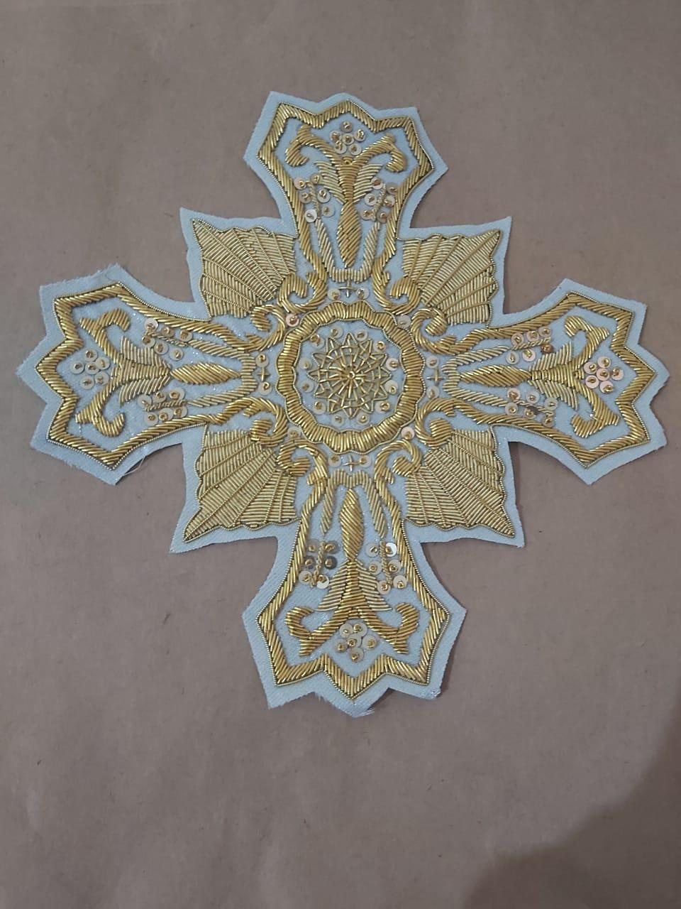 Powder blue cross with sequin sprays and medallion centre