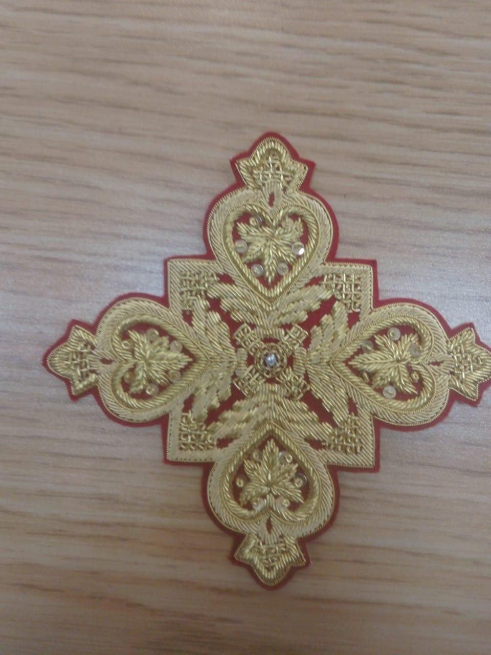 Gold cross on scarlet with heart and leaf motifs