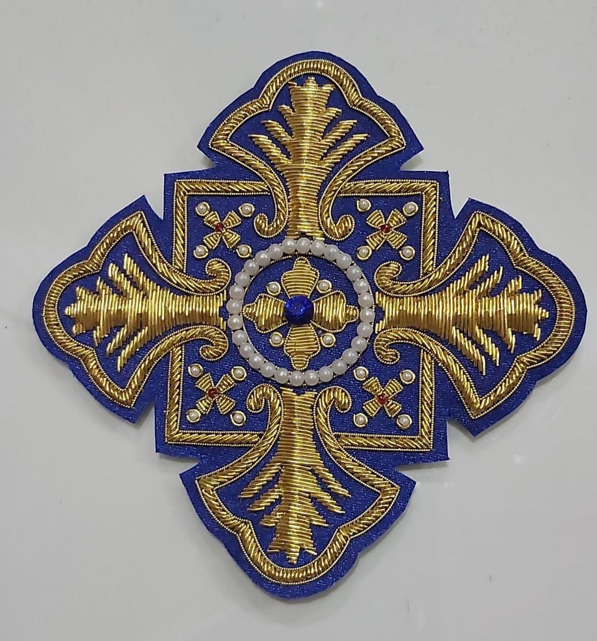 Royal blue cross with pearl ring and sapphire centre