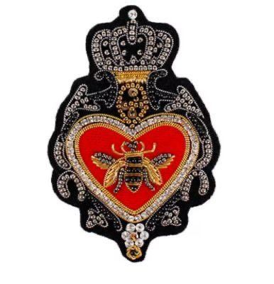Crowned heart with a golden bee on scarlet velvet