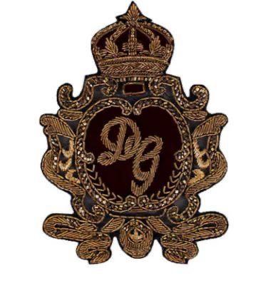 Monogram crest in antique gold on maroon velvet